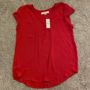 New red blouse from the Loft. Flutter sleeves and 4 buttons on top. V neck